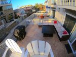 Private patio with furniture, a fire pit and grill for your enjoyment. East side of the dividing gate is the shared patio between all 8 units in the building.